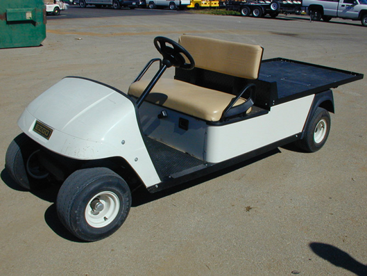 A white golf cart rental with an open design.